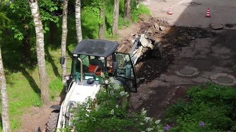 The excavator is doing road work . Working machine. Stock Footage 189995942