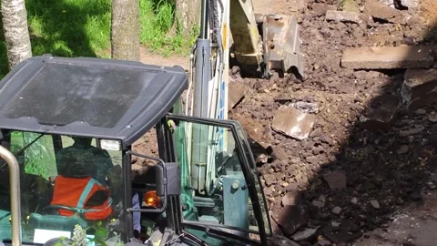 The excavator is doing road work . Working machine. Stock Footage 189996151