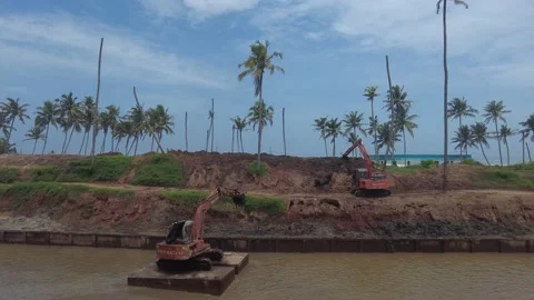 Excavator dredging sediment mud from canal in Thiruvananthapuram, Kerala Stock Footage 203836697
