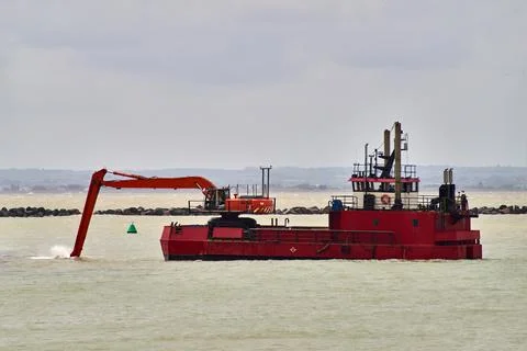 An excavator on a dredging ship Stock Photos