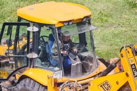 Excavator driver for control levers. Stock Photos