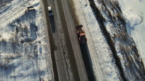 Excavator drives on the road in winter to work Stock Footage 149107007