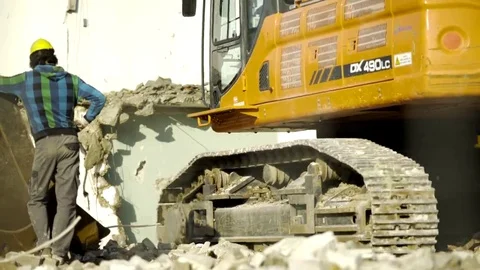 Excavator driving backwards on debris - 4K Stock Footage 69178463
