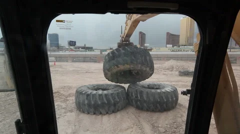 Excavator Dropping Giant Tire Stock Footage 55380628