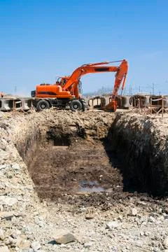 Excavator on the edge of the pit Stock Photos