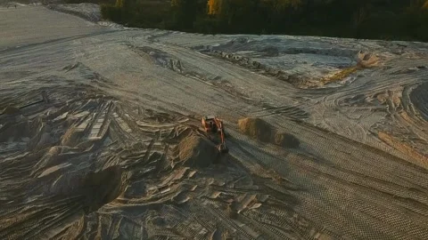Excavator evens sand surface at construction site during sunset Stock Footage 163359865