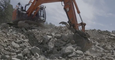 Excavator excavating rock construction site 3 Stock Footage