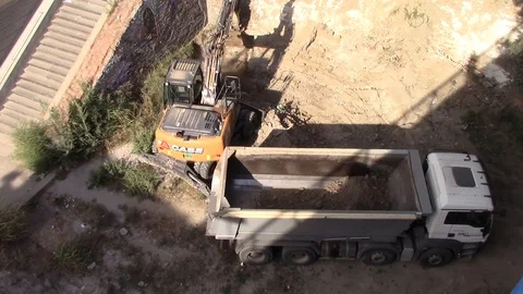 Excavator full truck with ground. An empty truck is pulled to the excavator Stock Footage 116318535