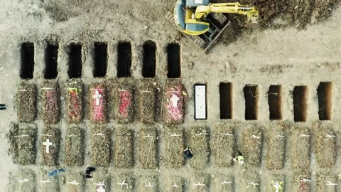 Excavator help to burial process Covid-19 victims Stock Footage 157675728