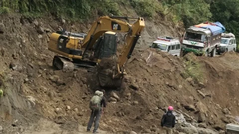An excavator improving a rough mountain road in the Himalaya Mountains. Stock Footage 144863759