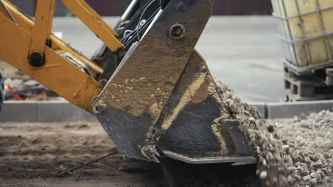 An Excavator with its Scoop Effectively Handling Gravel for Important Stock Footage 312461676