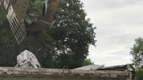 Excavator jaws loading debris - close Stock Footage 244938263