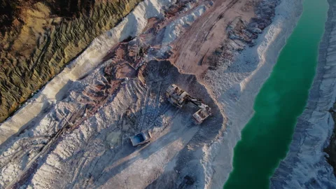 Excavator load limestone in mining truck in open pit mine. Stock Footage 186463264