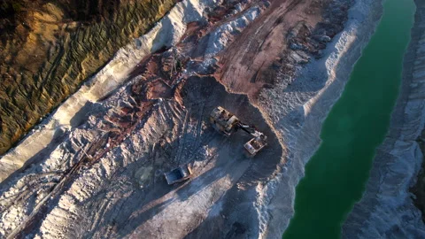 Excavator load limestone in mining truck in open pit mine. Stock Footage 186465727