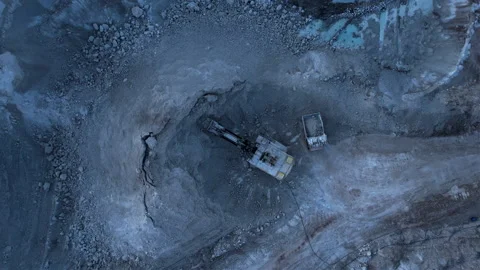 Excavator load limestone in mining truck in open pit mine. Stock Footage 186488025