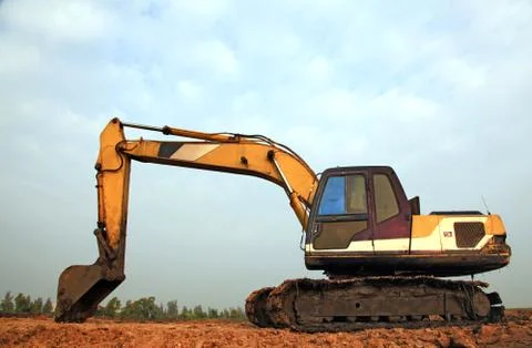 Excavator loader with backhoe standing in sandpit Stock Photos