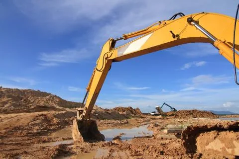 Excavator loader machine during earthmoving works outdoors at construction si Stock Photos