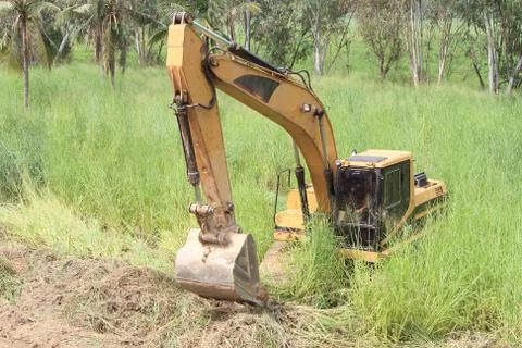 Excavator loader machine during earthmoving works outdoors at construction si Stock Photos