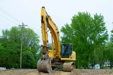 Excavator loader machine during earthmoving works outdoors Stock Photos
