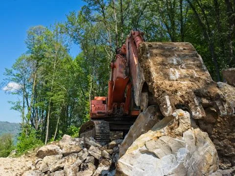 Excavator loader machine at road construction site. Stock Photos