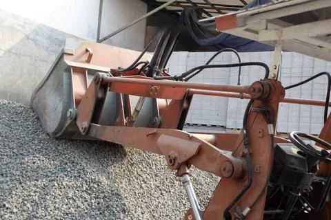 Excavator loader or backhoe is scooping crushed stone Stock Photos