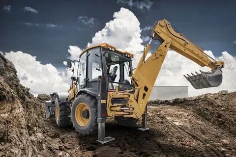 Excavator loader performs work on a construction site moving soil and rocks.. Stock Photos