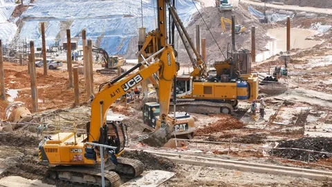 Excavator loader at soil moving works in construction site. Stockbeeldmateriaal 85620585