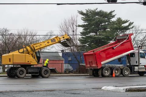 Excavator loading big dump truck Stock Photos