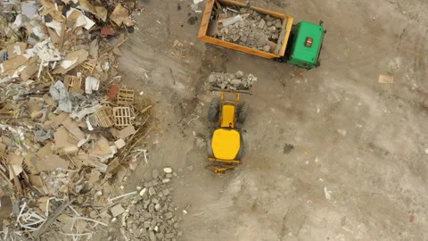 Excavator is loading construction debris into a dump truck at a construction  Stock Footage 163124634