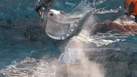 The excavator loading crushed stone into a dump truck in a crushed stone quarry Stock Footage 211437174