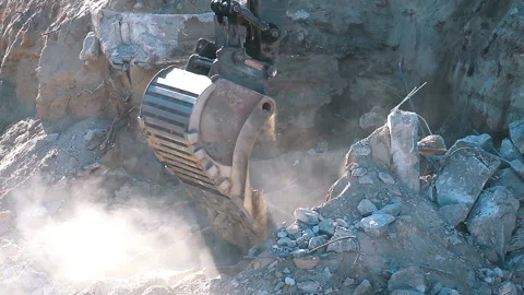 The excavator loading crushed stone into a dump truck in a crushed stone quarry Stock Footage 211437432