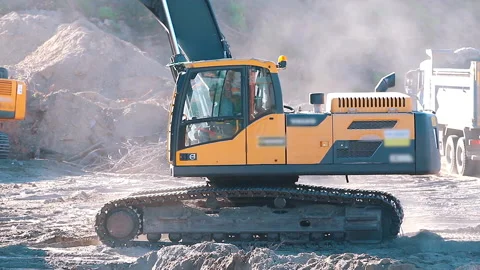 The excavator loading crushed stone into a dump truck in a crushed stone quarry Stock Footage 211437697