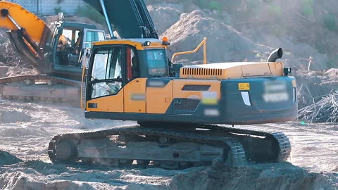 The excavator loading crushed stone into a dump truck in a crushed stone quarry Stock Footage 211437813