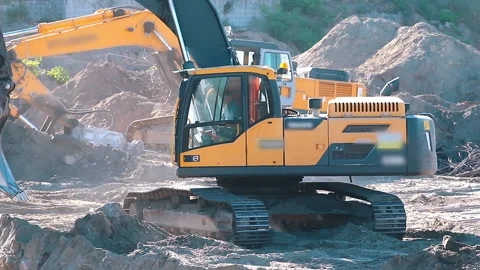 The excavator loading crushed stone into a dump truck in a crushed stone quarry Stock Footage 211437988