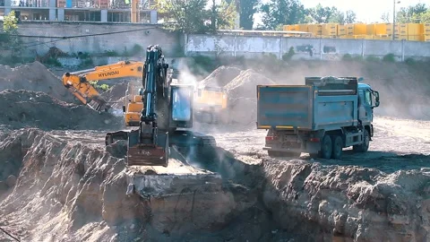 The excavator loading crushed stone into a dump truck in a crushed stone quarry Stock Footage 228718605