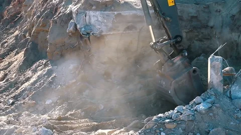 The excavator loading crushed stone into a dump truck in a crushed stone quarry Stock Footage 228718678