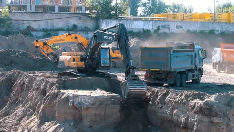 The excavator loading crushed stone into a dump truck in a crushed stone quarry Stock Footage 228718707