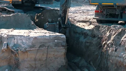 The excavator loading crushed stone into a dump truck in a crushed stone quarry Stock Footage 228718734
