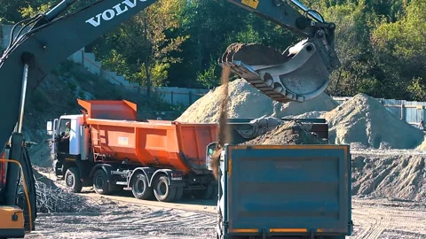 The excavator loading crushed stone into a dump truck in a crushed stone quarry Stock Footage 228718764
