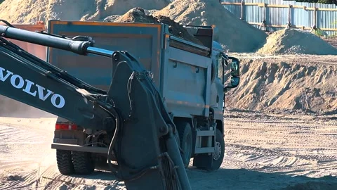The excavator loading crushed stone into a dump truck in a crushed stone quarry Stock Footage 228718787