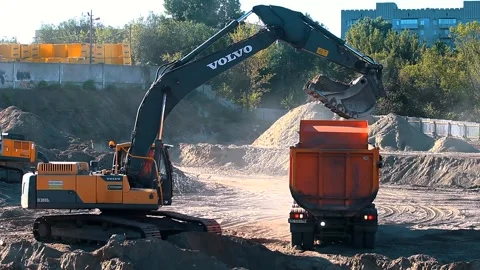 The excavator loading crushed stone into a dump truck in a crushed stone quarry Stock Footage 228718874