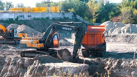 The excavator loading crushed stone into a dump truck in a crushed stone quarry Stock Footage 228718948