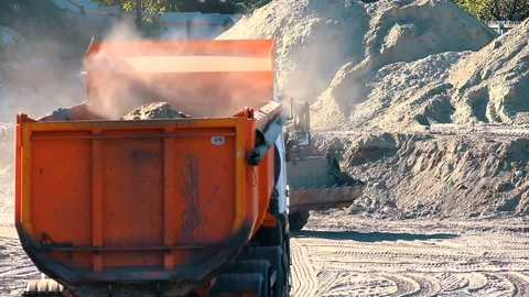 The excavator loading crushed stone into a dump truck in a crushed stone quarry Stock Footage 228718978