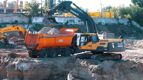 The excavator loading crushed stone into a dump truck in a crushed stone quarry Stock Footage 228719037
