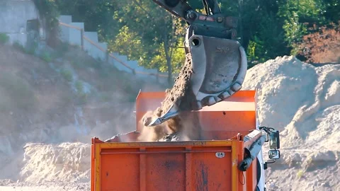 The excavator loading crushed stone into a dump truck in a crushed stone quarry Stock Footage 228719059