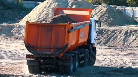 The excavator loading crushed stone into a dump truck in a crushed stone quarry Stock Footage 228719168