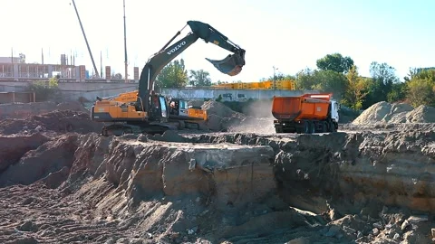 The excavator loading crushed stone into a dump truck in a crushed stone quarry Stock Footage 228719223