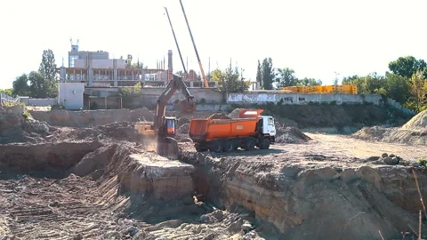 The excavator loading crushed stone into a dump truck in a crushed stone quarry Stock Footage 228719273