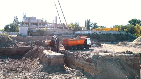The excavator loading crushed stone into a dump truck in a crushed stone quarry Stock Footage 228719305