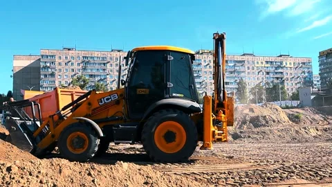 The excavator loading crushed stone into a dump truck in a crushed stone quarry Stock Footage 228733193